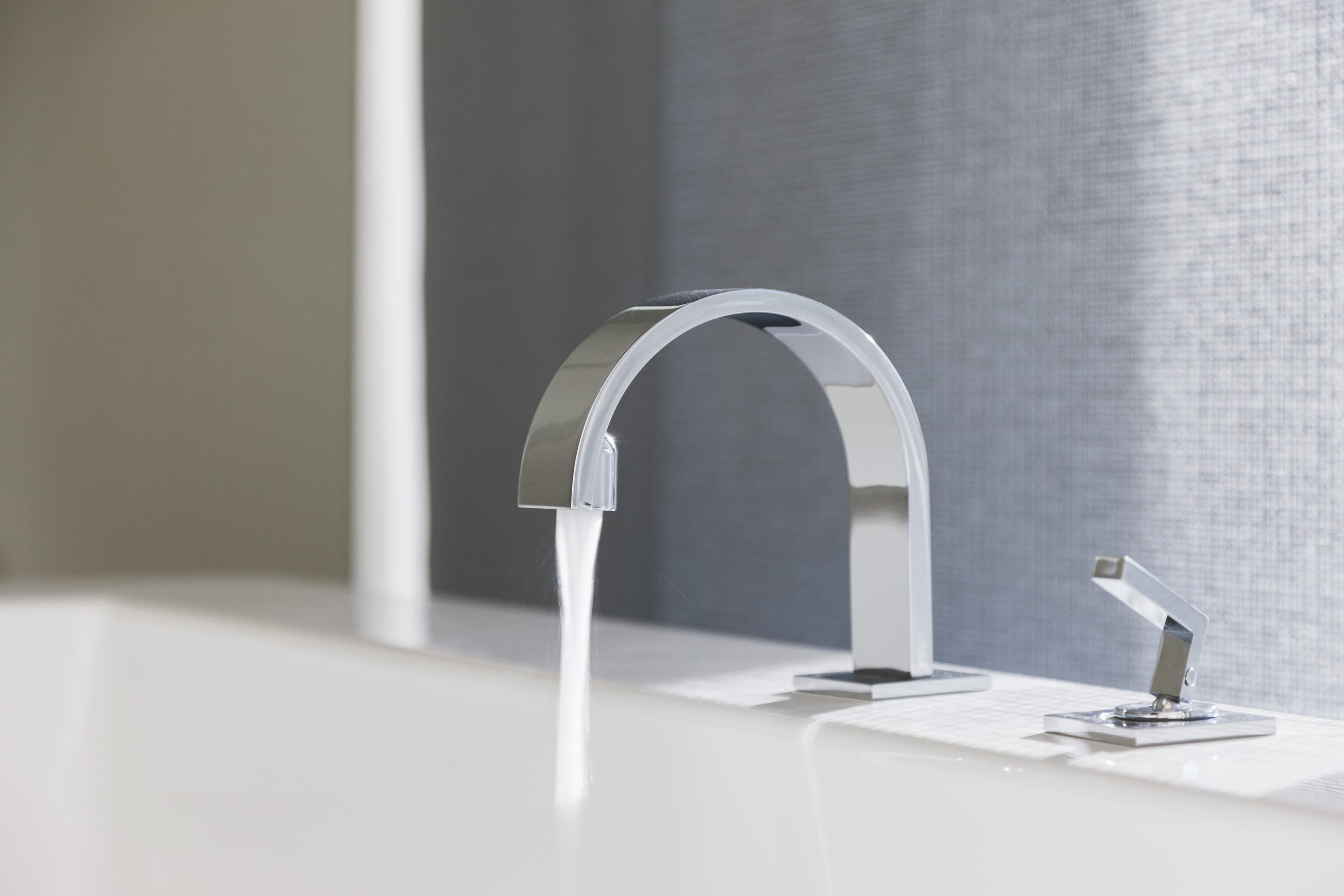 Chrome bathroom faucet with water running
